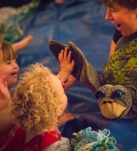 Oddysea - © Jessica Wyld / Actress using turtle puppet to interact with disabled children audience